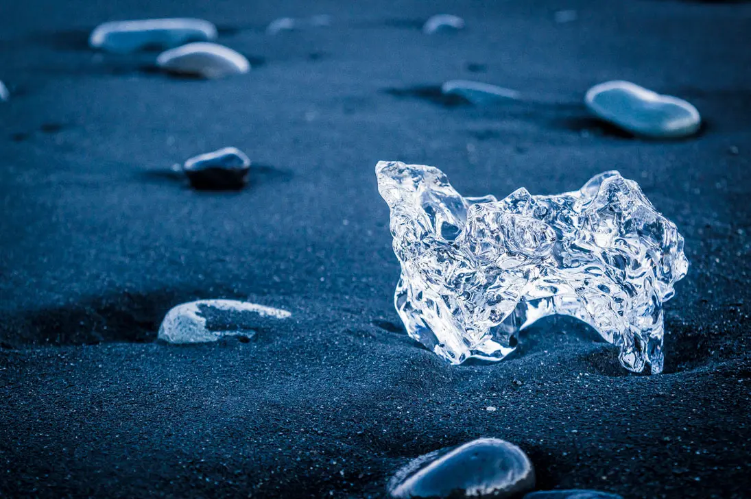 sable noir et bloc de glace à Diamond beach